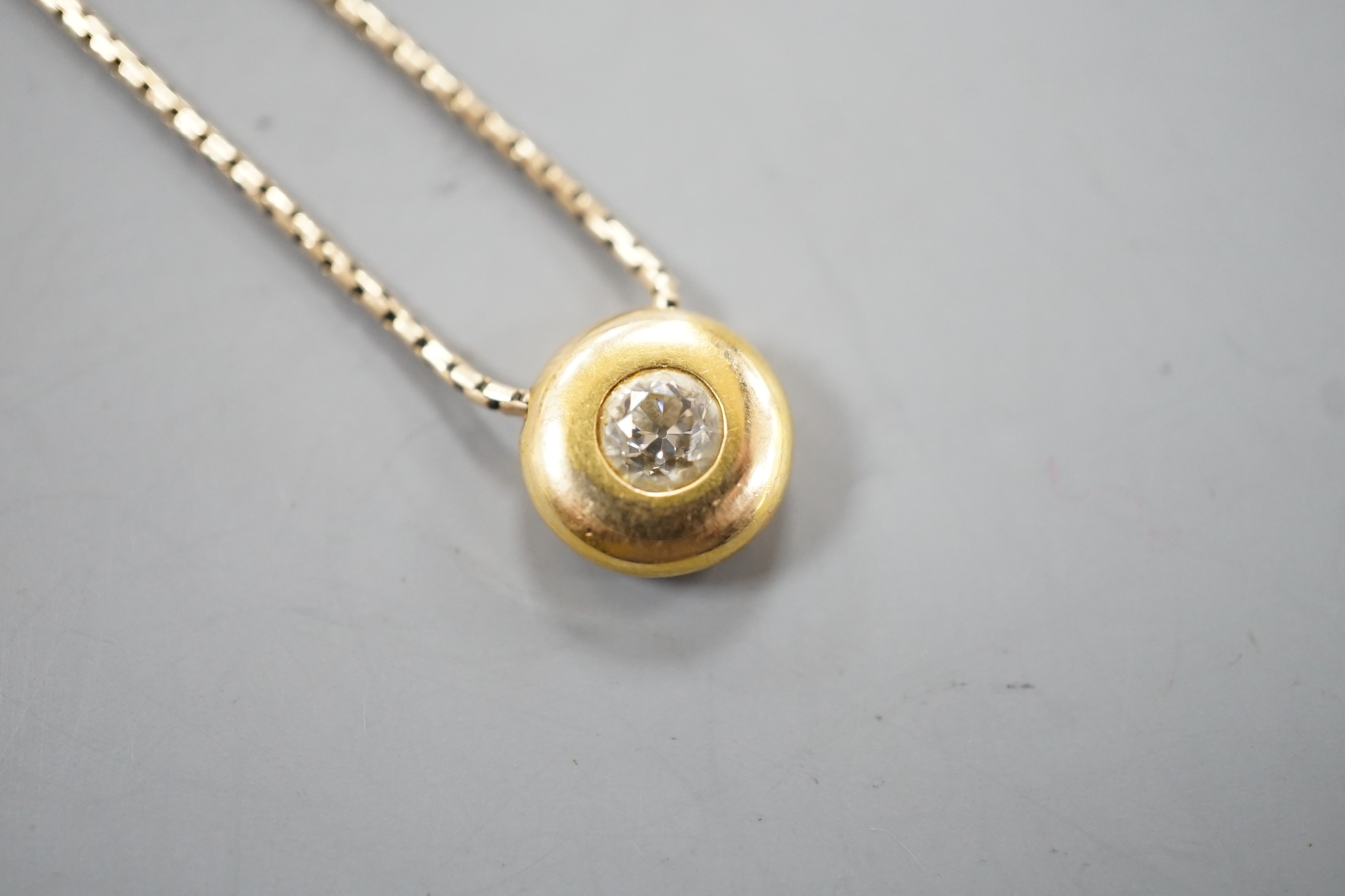 A modern 9ct gold and solitaire diamond set pendant necklace, pendant 9mm, chain, 39cm, gross weight 4.5 grams.
